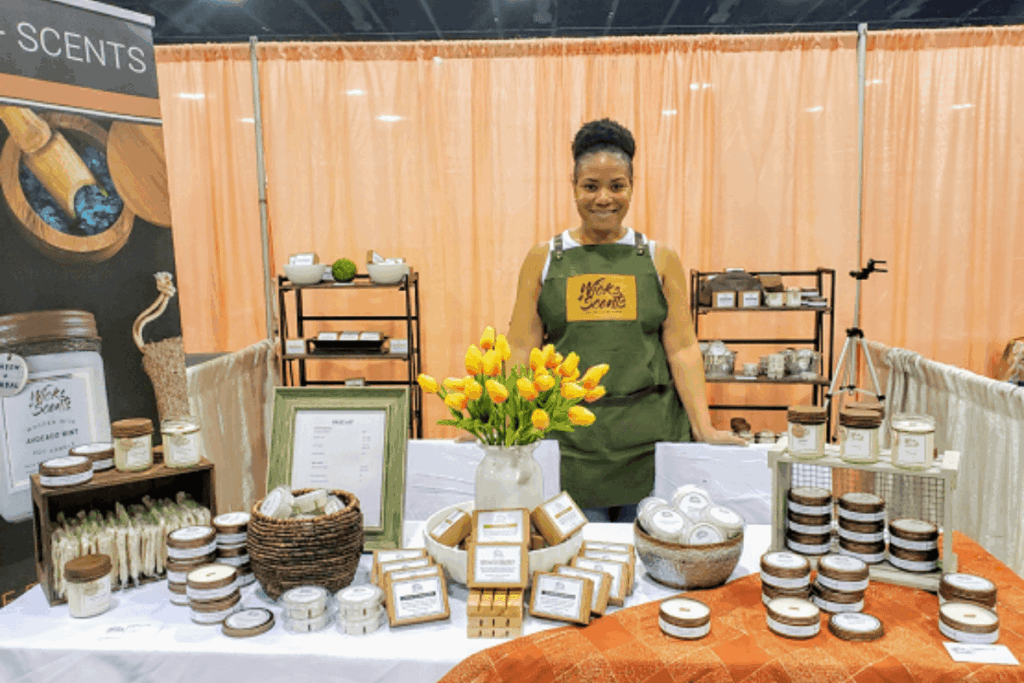 African American female entrepreneur selling soy candles and natural bar soaps at an event